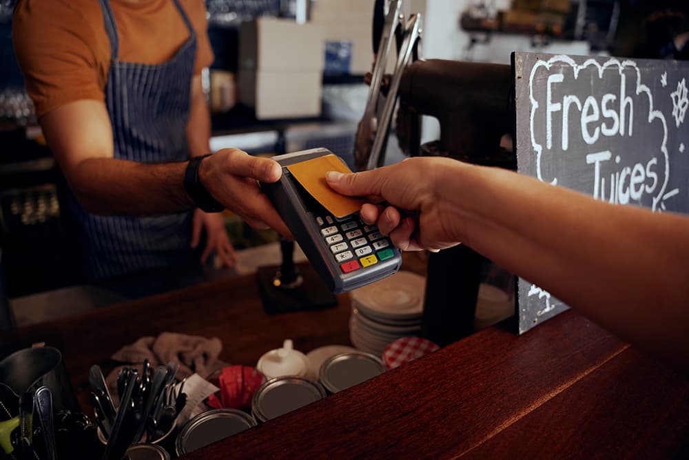 Man holding credit card reader